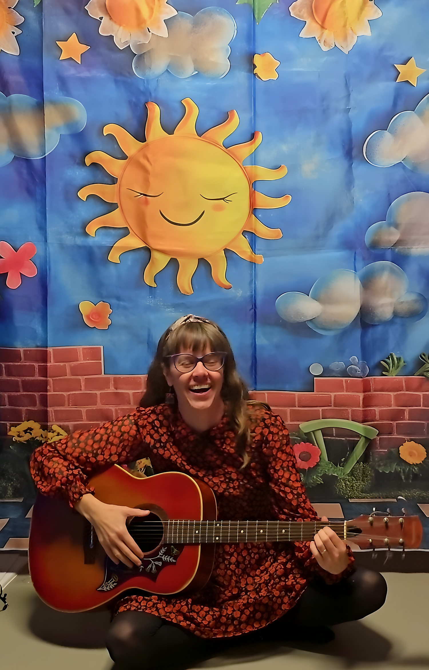 Aga playing guitar during a workshop
